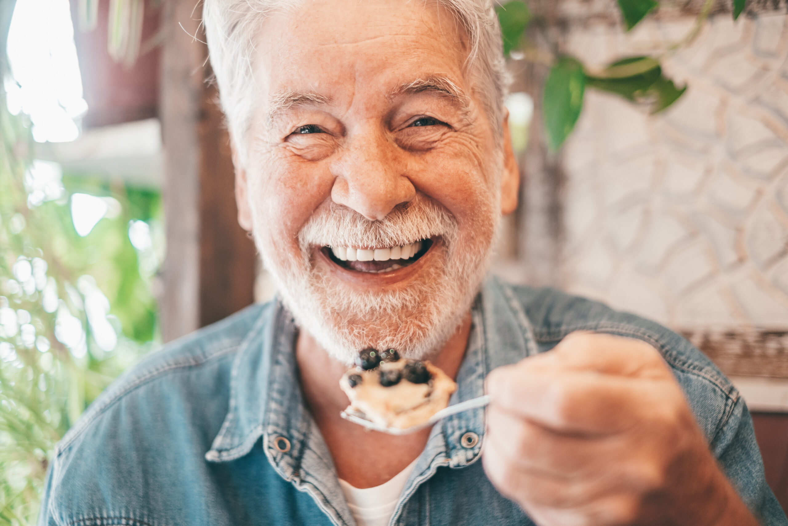 Older man, happily enjoying a meal.