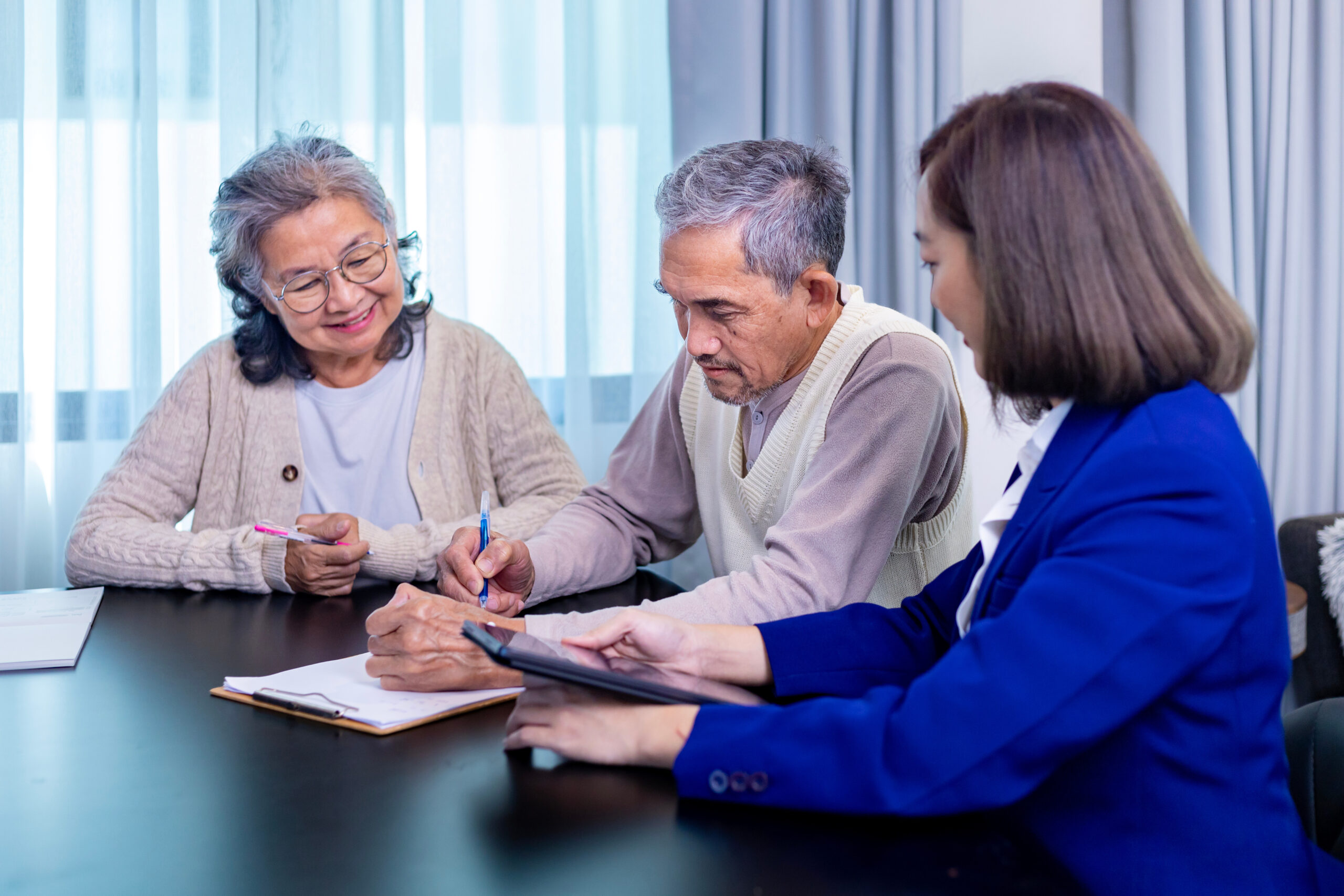 Asian senior couple is signing legal financial contract and insurance health care benefit for retirement home visit service by professional lawyer consultant