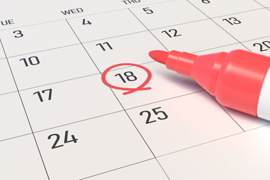 close-up of a calendar sheet, marker and a date marked with a red circle.